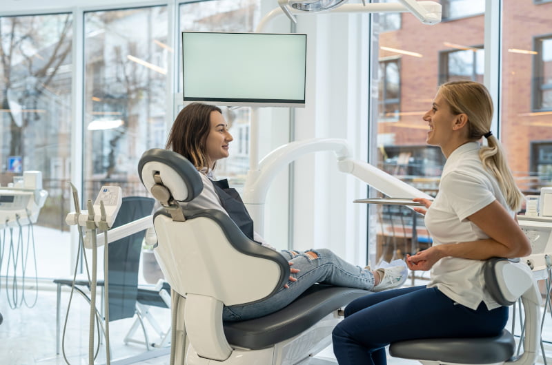 Dentist discussing the Canadian Dental Care Plan and full-arch treatment options with a patient