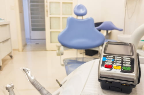 Patient making a dental payment at the clinic reception related to CDCP co-payments