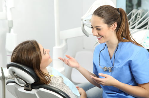 Dentist explaining a dental procedure to a patient during a consultation