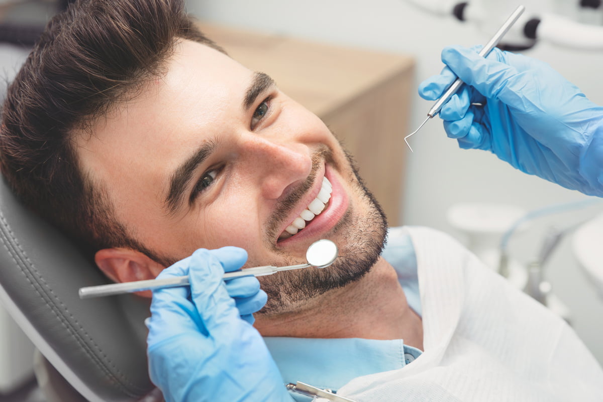 Patient receiving a cosmetic dental examination and smile assessment at a dental clinic in Barrie