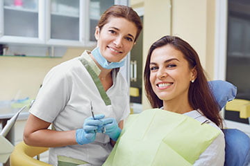 Dentist discussing dental crown treatment options with a patient in a dental clinic.