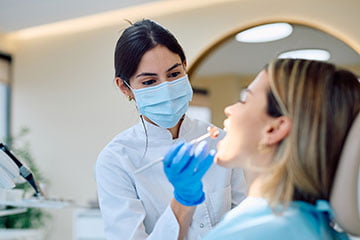Dentist examining a patient while planning a customized smile makeover treatment.