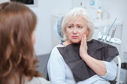 Patient experiencing wisdom tooth pain during an emergency dental visit in Barrie