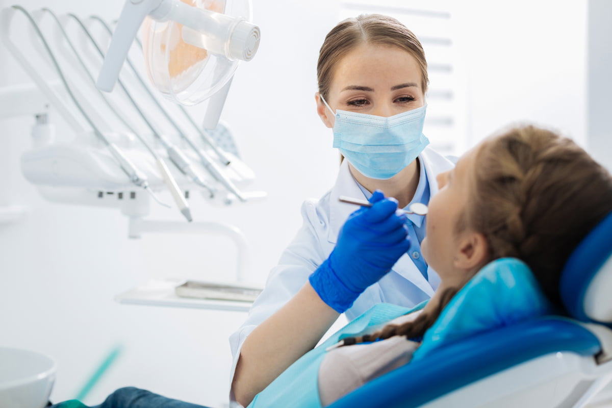 Female dentist consulting with a patient about oral health conditions during a dental appointment