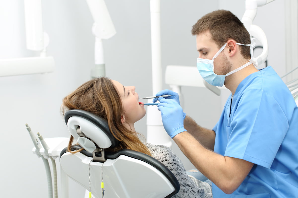 Dentist discussing long-term oral health and treatment planning with a patient during a dental consultation