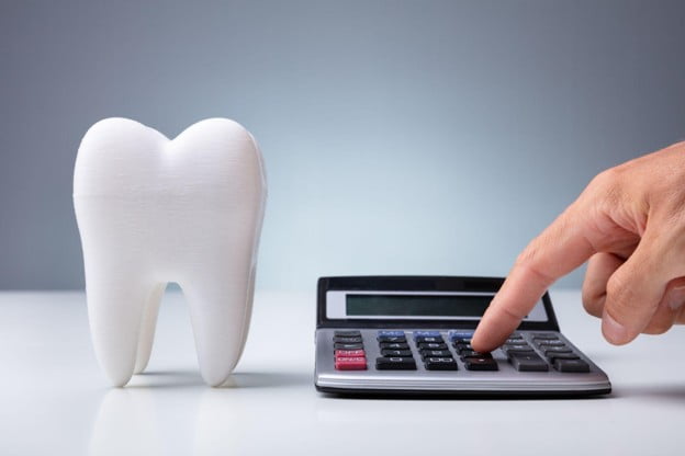 Tooth model and calculator illustrating the cost of porcelain veneers in Barrie, Ontario