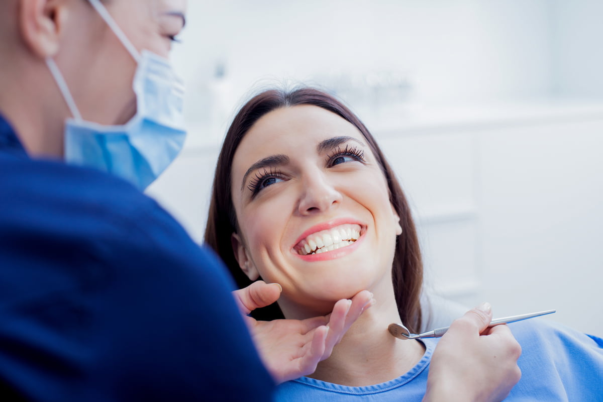 Woman receiving a preventive dental examination during a routine check-up at a dental clinic