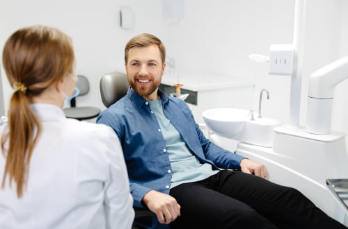 A dentist discussing preventive and diagnostic dental care with a patient during a consultation