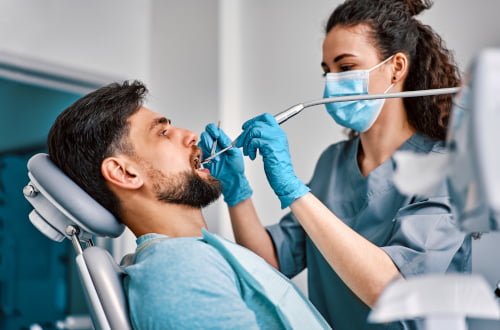A dentist performing prosthodontic dental treatment during a restorative care appointment