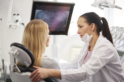 Dentist explaining root canal treatment to a patient in Barrie dental clinic