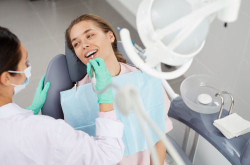 Dentist examining a patient’s teeth during a dental checkup to assess oral health