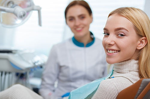 Dentist consulting with a patient during an appointment at a Smile Centre dental clinic