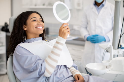 Happy female patient smiling after professional teeth whitening in Barrie