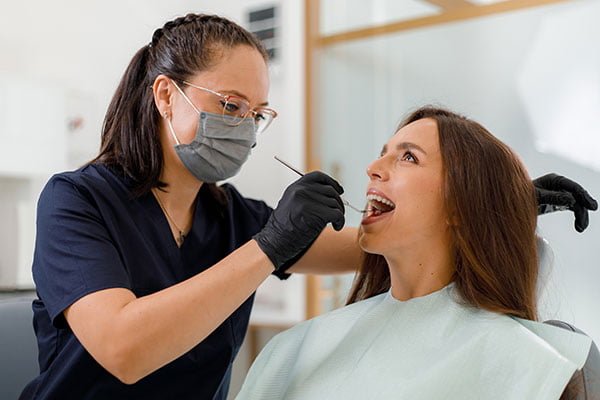 Dentist providing aftercare instructions to a patient following wisdom teeth removal at a dental clinic