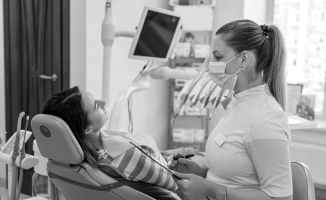 Dentist consulting with a patient about All-on-X dental implants in Barrie before full-arch tooth replacement treatment.