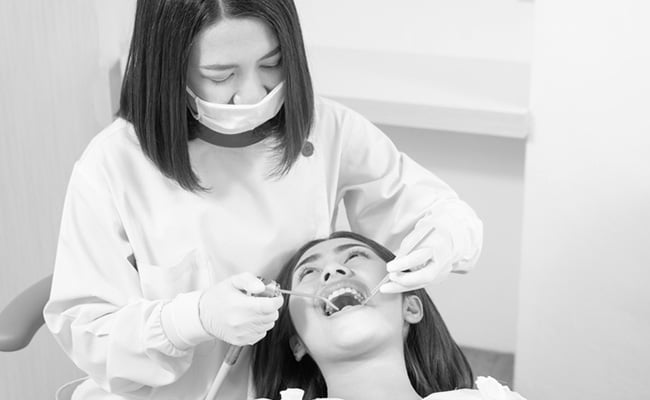 Dentist examining a patient during a non-surgical gum therapy consultation in a Barrie dental clinic