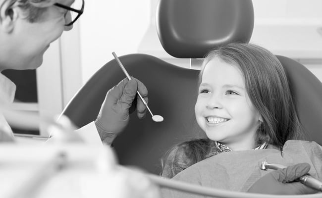 Young girl receiving a gentle dental examination during a pediatric dentistry appointment in Barrie