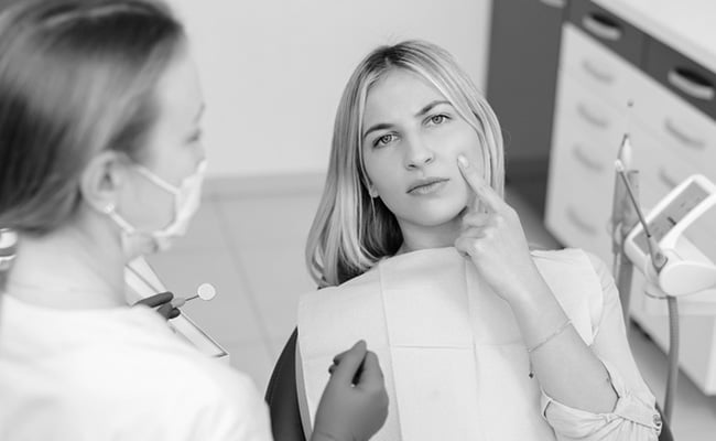Dentist consulting with a patient about root canal treatment during a dental appointment in Barrie