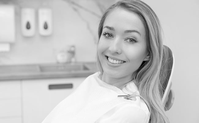 Young woman smiling during a smile makeover consultation at a dental clinic in Barrie