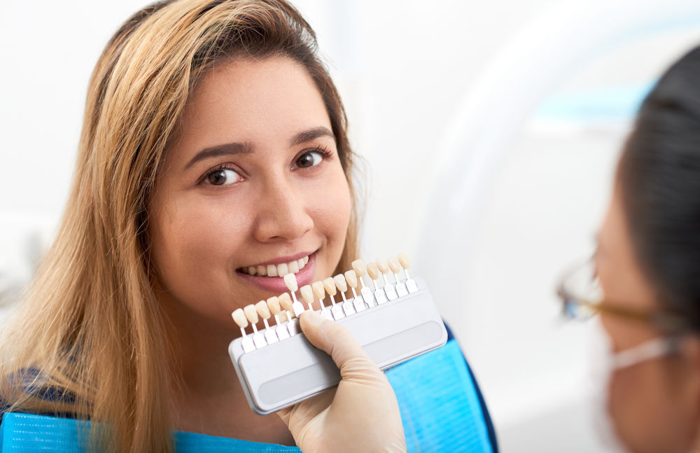 Young patient visiting a dentist for a cosmetic dental consultation related to porcelain veneers and smile enhancement treatment