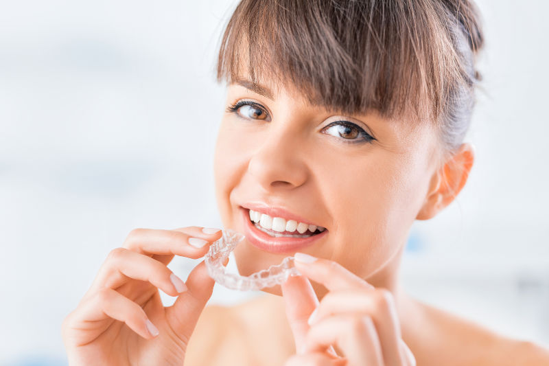 Beautiful smile and white teeth of a young woman after Invisalign treatment