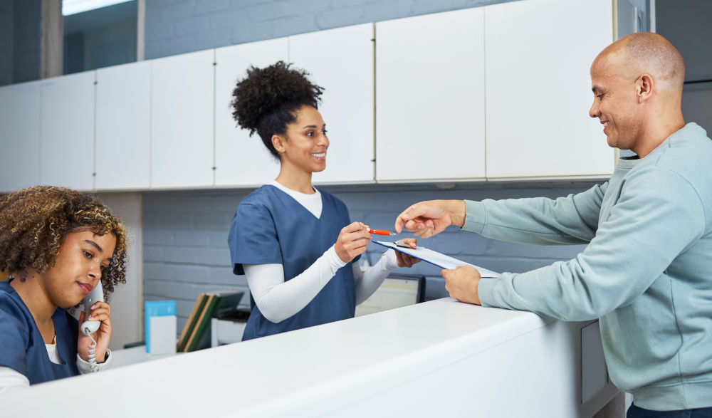 Reception staff assisting dental patients with CDCP coverage at a modern dental clinic in Barrie