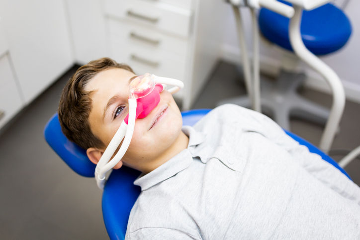 Young boy sitting in a dentist chair during a pediatric sedation dentistry appointment in Barrie