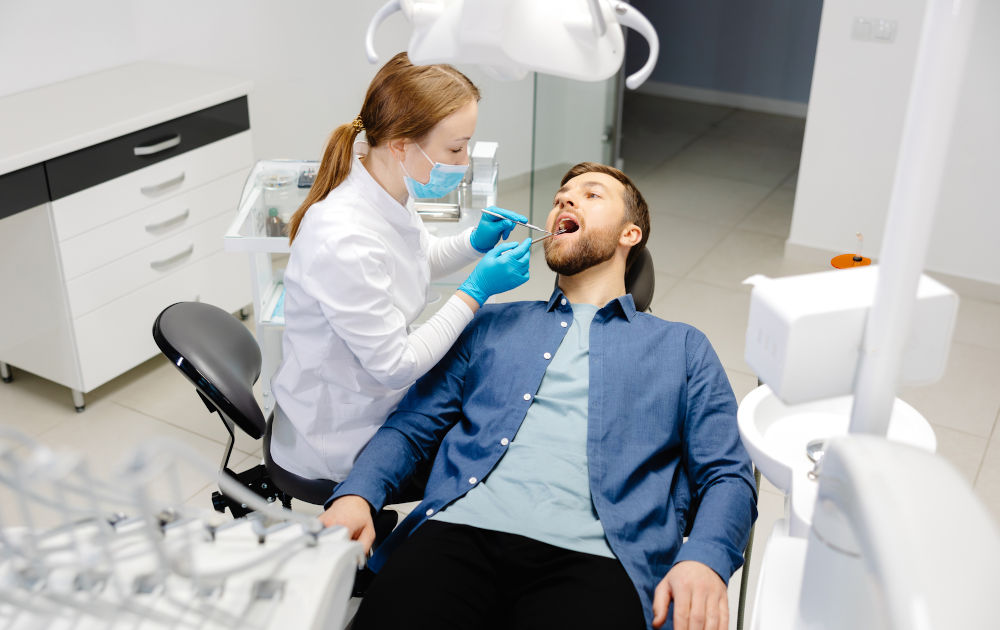 Patient speaking with a dentist before wisdom teeth removal surgery at a dental clinic in Barrie