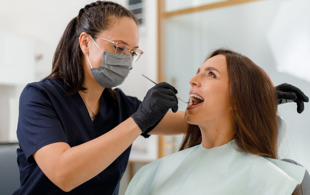 Dentist performing a dental checkup to diagnose and treat a cracked tooth in a patient at a dental clinic