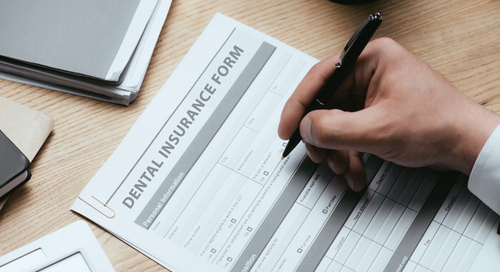 Self-employed individual reviewing dental insurance options and coverage details