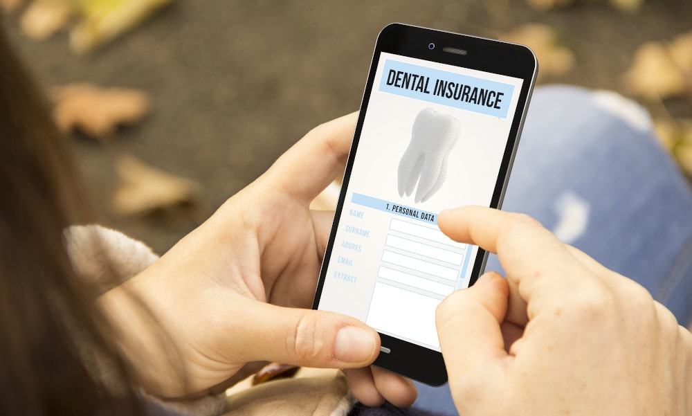 Woman reviewing dental insurance benefits and coverage on her phone