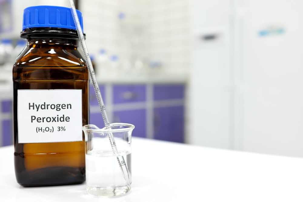 Diluted hydrogen peroxide mouthwash solution in a glass container.