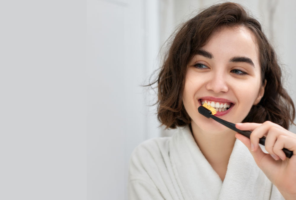A close-up of a smiling woman with sparkling white teeth, symbolizing good oral hygiene and dental health.